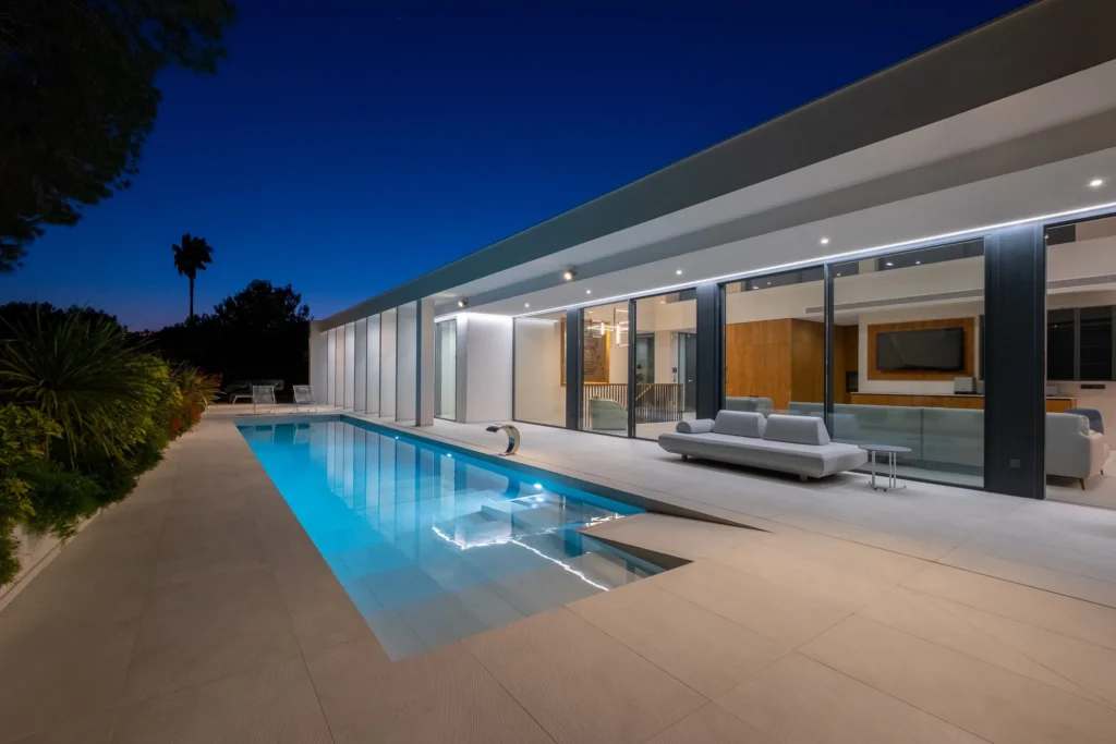 Villa exterior with pool at dusk